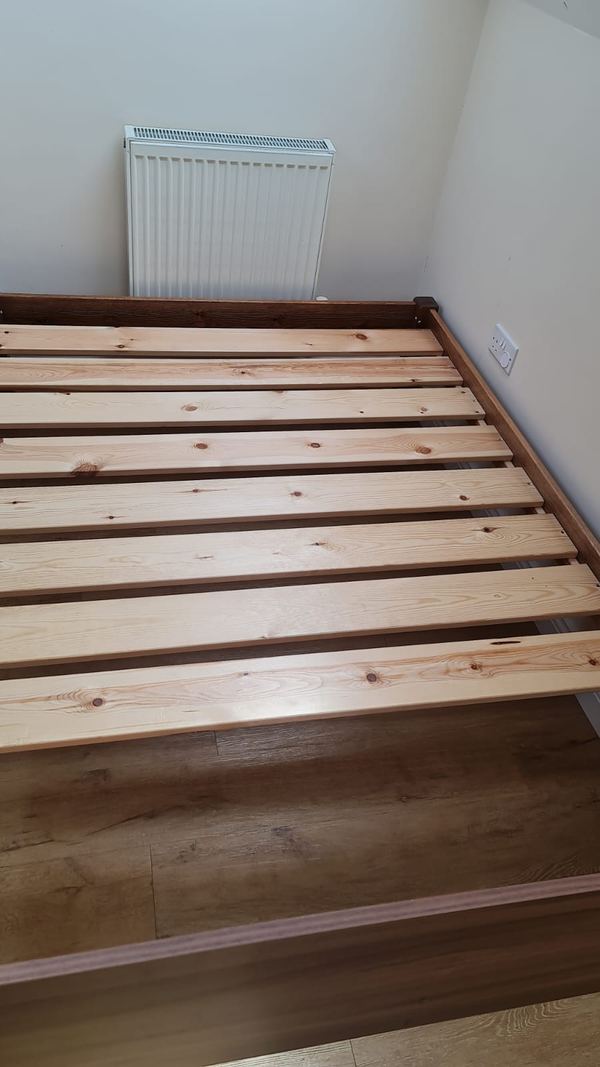 Wooden bed frame rebuilt with new slats