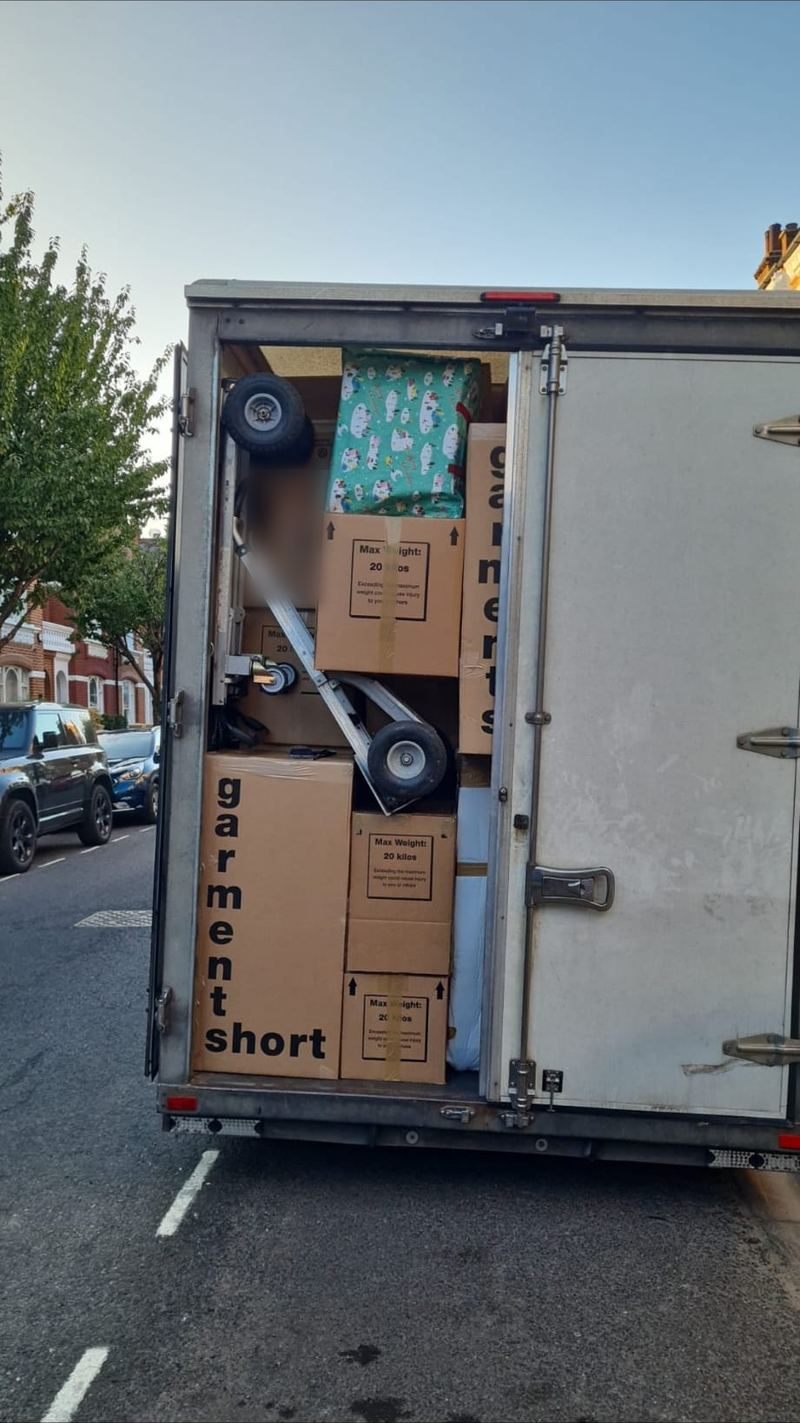 Boxes and wardrobe cartons packed tightly in a removals van
